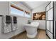 Spa bathroom featuring a freestanding tub with modern fixtures and a decorative accent wall, and a window at 10991 Expedition, Littleton, CO 80125