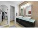 Modern bathroom with double sinks, stylish mirrors, and tiled walls at 10991 Expedition, Littleton, CO 80125