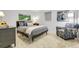 Serene bedroom with grey bed, a colorful chair, artwork on the walls and a small bedside table at 10991 Expedition, Littleton, CO 80125
