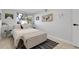 Bright bedroom with a white bed and a decorative blanket chest providing extra storage in the room at 10991 Expedition, Littleton, CO 80125