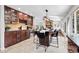 Open kitchen features cherry wood cabinets, large island with seating, stone fireplace and hardwood floors at 10991 Expedition, Littleton, CO 80125