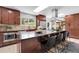 Cherry cabinets accent the kitchen with stainless steel appliances and an island with seating at 10991 Expedition, Littleton, CO 80125