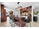 Open kitchen featuring a large center island, counter seating, pendant lighting, and ample cabinet space at 10991 Expedition, Littleton, CO 80125