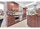 The kitchen boasts cherry cabinets, a stainless steel microwave, and granite countertops overlooking the backyard at 10991 Expedition, Littleton, CO 80125