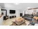 Cozy living room with stone fireplace, mounted TV, and plush couches is a perfect space to relax at 10991 Expedition, Littleton, CO 80125