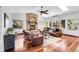 Cozy living room with stone fireplace, hardwood floors, skylights, and comfortable seating arrangement at 10991 Expedition, Littleton, CO 80125