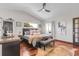 Main bedroom featuring hardwood floors, a ceiling fan, and modern decor at 10991 Expedition, Littleton, CO 80125