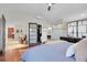 Spacious main bedroom with hardwood floors, an ensuite bathroom, and access to a closet at 10991 Expedition, Littleton, CO 80125