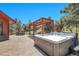 Outdoor patio area with a hot tub, pergola, lounge seating, and lush greenery at 10991 Expedition, Littleton, CO 80125