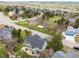 Aerial view of the home highlighting the large yard, mature trees, and proximity to community areas at 7307 Pine Forest Ln, Parker, CO 80134