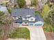 Stunning aerial view of a two-story home with a three-car garage and beautiful landscaping at 7307 Pine Forest Ln, Parker, CO 80134