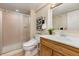 Bathroom featuring vanity, toilet, framed mirror, and a walk-in shower at 7307 Pine Forest Ln, Parker, CO 80134
