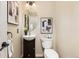 A well-lit powder room featuring a round mirror and contemporary fixtures at 7307 Pine Forest Ln, Parker, CO 80134