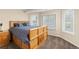 Traditional bedroom featuring a wood bed frame, ample natural light, and built-in storage at 7307 Pine Forest Ln, Parker, CO 80134