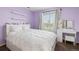 Bedroom featuring purple paint, a large window, shelves, and a make-up vanity at 7307 Pine Forest Ln, Parker, CO 80134