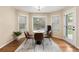 Cozy breakfast nook with a round table, modern chairs, and natural light from three windows at 7307 Pine Forest Ln, Parker, CO 80134