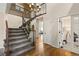 Inviting entryway with hardwood floors, an elegant staircase, and views into other living spaces at 7307 Pine Forest Ln, Parker, CO 80134