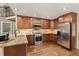 Well-equipped kitchen with stainless steel appliances, granite countertops, and wood cabinetry at 7307 Pine Forest Ln, Parker, CO 80134