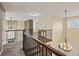 Second floor landing with metal railing overlooking the entryway, a light fixture, and nice carpets at 7307 Pine Forest Ln, Parker, CO 80134