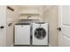 Practical laundry room with a washer, dryer, shelving, and ample storage space at 7307 Pine Forest Ln, Parker, CO 80134