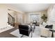 Comfortable living room with plush seating, a large window, and views of the entryway at 7307 Pine Forest Ln, Parker, CO 80134