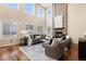 Bright living room with high ceilings, a brick fireplace, and large windows at 7307 Pine Forest Ln, Parker, CO 80134