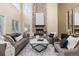 Cozy living room featuring a brick fireplace, plush seating, and a stylish coffee table at 7307 Pine Forest Ln, Parker, CO 80134