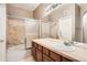 Well-lit bathroom with a shower and bath, featuring tiled walls and ample counter space at 6742 S Winnipeg Cir # 105, Aurora, CO 80016