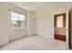 This bedroom features neutral walls, carpet, a closet, and a window for natural light at 6742 S Winnipeg Cir # 105, Aurora, CO 80016
