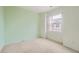 Bright bedroom with carpet, a window, and light green walls, offering a cozy living space at 6742 S Winnipeg Cir # 105, Aurora, CO 80016