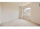 This bedroom features neutral walls, carpet, and a window for natural light at 6742 S Winnipeg Cir # 105, Aurora, CO 80016