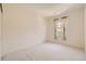 This bedroom features neutral walls, carpet, and a window for natural light at 6742 S Winnipeg Cir # 105, Aurora, CO 80016