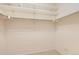 Walk-in closet has neutral walls, and multiple white shelves for storage at 6742 S Winnipeg Cir # 105, Aurora, CO 80016