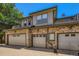 Row of garages showing garage doors, brick facade, and overhead lighting at 6742 S Winnipeg Cir # 105, Aurora, CO 80016