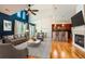 Bright living room boasts vaulted ceilings, hardwood floors, fireplace, and open floor plan to kitchen and dining area at 6742 S Winnipeg Cir # 105, Aurora, CO 80016