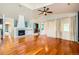 Spacious living room with fireplace, vaulted ceilings, hardwood floors and open access to a staircase and other rooms at 6742 S Winnipeg Cir # 105, Aurora, CO 80016