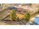 Aerial view of a home showcasing a spacious backyard with a fire pit and mature landscaping at 6812 Blue Jay Dr, Parker, CO 80138