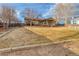 Expansive backyard featuring a well-kept lawn, a charming covered patio, and mature trees at 6812 Blue Jay Dr, Parker, CO 80138