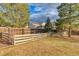 Fenced backyard with mature trees and a lawn; perfect for outdoor activities and relaxation at 6812 Blue Jay Dr, Parker, CO 80138