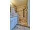 Bathroom featuring a tiled walk-in shower with decorative mosaic accents and a modern vanity at 6812 Blue Jay Dr, Parker, CO 80138