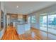 Contemporary kitchen featuring stainless appliances, quartz countertops and hardwood floors at 6812 Blue Jay Dr, Parker, CO 80138