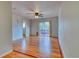 Bright living room with hardwood floors, ceiling fan, and sliding glass door leading to the outdoors at 6812 Blue Jay Dr, Parker, CO 80138