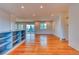 Spacious living room featuring hardwood floors, recessed lighting, and sliding glass door to backyard at 6812 Blue Jay Dr, Parker, CO 80138