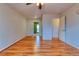 Bright living room with hardwood floors, ceiling fan, and sliding glass door leading to the outdoors at 6812 Blue Jay Dr, Parker, CO 80138