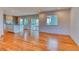 Bright and airy living room featuring hardwood floors that flow into the modern kitchen at 6812 Blue Jay Dr, Parker, CO 80138