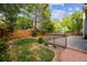 Lush backyard with a wooden deck, manicured lawn, and mature landscaping, perfect for outdoor living at 15597 E Dorado Ave, Centennial, CO 80015