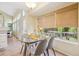 Bright breakfast nook featuring a glass table, stylish chairs, and a large window overlooking the backyard at 15597 E Dorado Ave, Centennial, CO 80015
