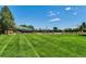 Well-maintained community pool surrounded by a lush green lawn and various amenities at 15597 E Dorado Ave, Centennial, CO 80015