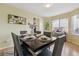 Elegant dining room featuring a modern table set and ample natural light from the bay windows at 15597 E Dorado Ave, Centennial, CO 80015