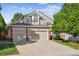 Inviting home with a brick-accented facade, two-car garage, and well-maintained lawn at 15597 E Dorado Ave, Centennial, CO 80015